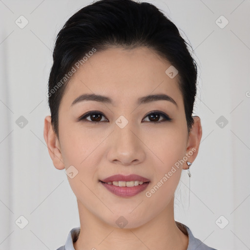 Joyful asian young-adult female with short  black hair and brown eyes