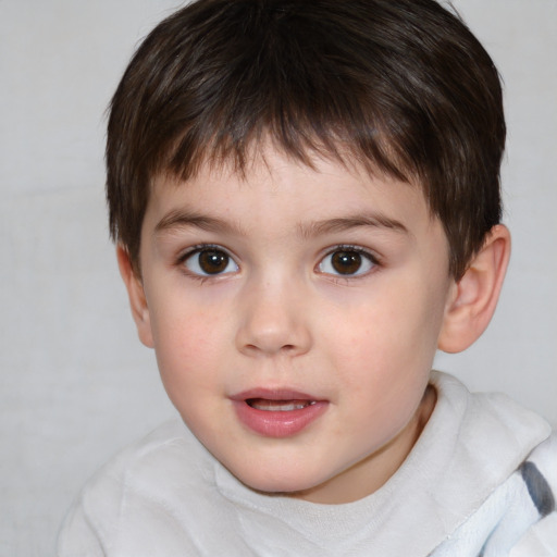 Joyful white child male with short  brown hair and brown eyes