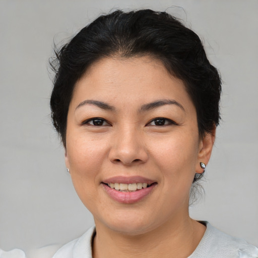 Joyful asian young-adult female with short  brown hair and brown eyes
