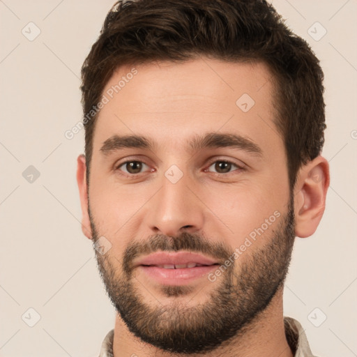 Joyful white young-adult male with short  brown hair and brown eyes