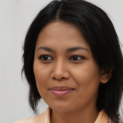Joyful asian young-adult female with medium  black hair and brown eyes