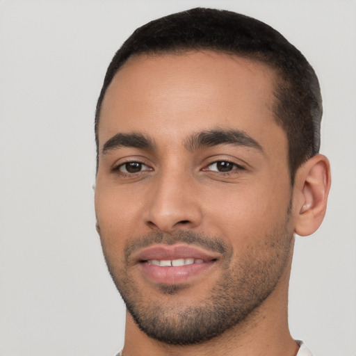 Joyful white young-adult male with short  black hair and brown eyes