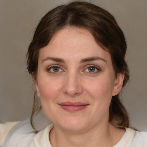 Joyful white adult female with medium  brown hair and brown eyes