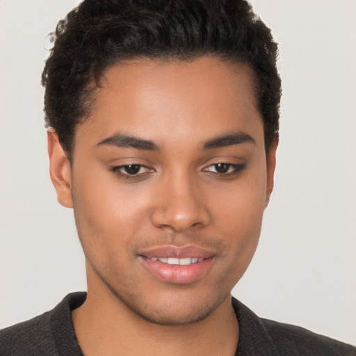 Joyful latino young-adult male with short  brown hair and brown eyes