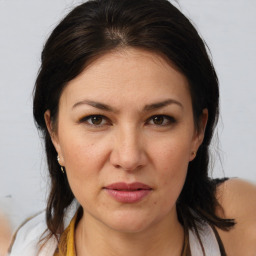 Joyful white adult female with medium  brown hair and brown eyes