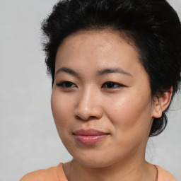 Joyful asian young-adult female with short  black hair and brown eyes