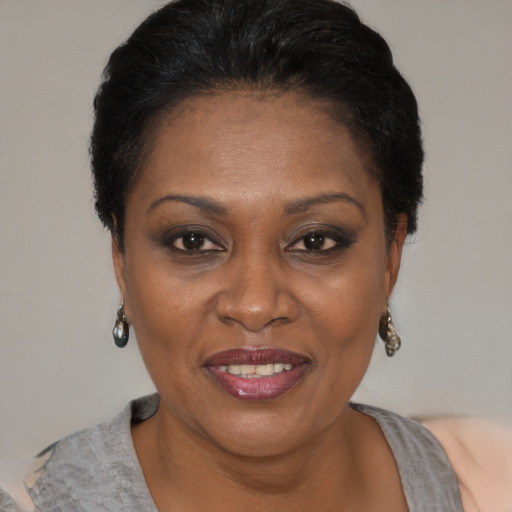 Joyful black adult female with short  brown hair and brown eyes
