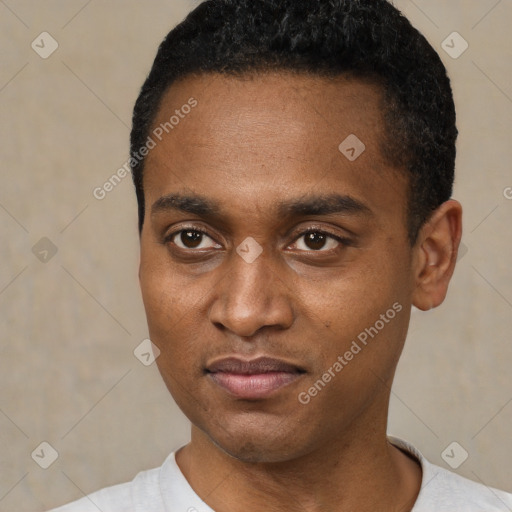 Joyful black young-adult male with short  black hair and brown eyes