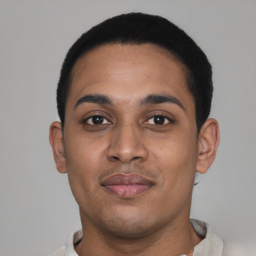 Joyful latino young-adult male with short  black hair and brown eyes