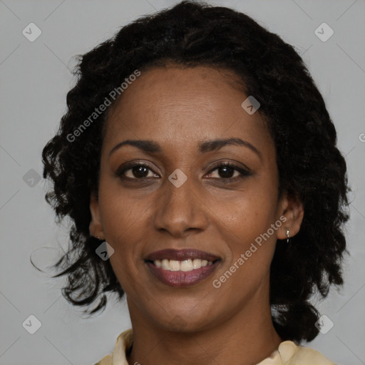 Joyful black adult female with medium  brown hair and brown eyes