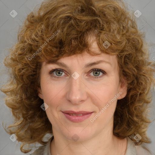 Joyful white adult female with medium  brown hair and green eyes