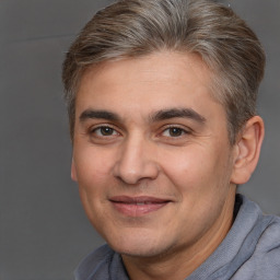 Joyful white adult male with short  brown hair and brown eyes