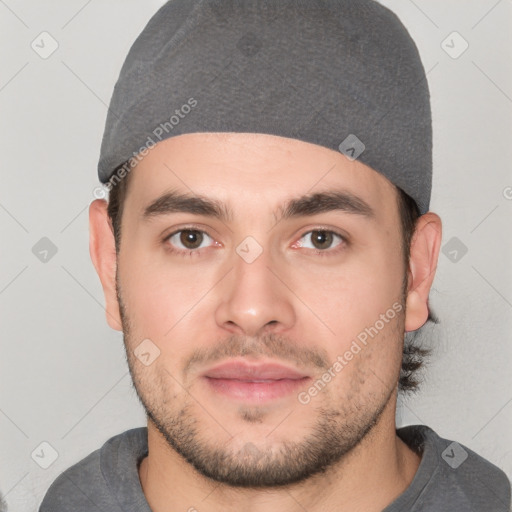 Joyful white young-adult male with short  black hair and brown eyes