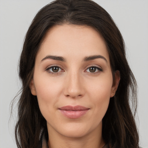 Joyful white young-adult female with long  brown hair and brown eyes