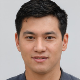 Joyful asian young-adult male with short  black hair and brown eyes