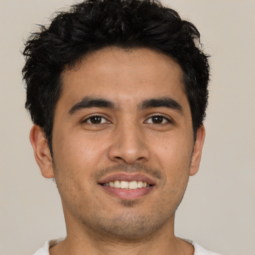 Joyful latino young-adult male with short  black hair and brown eyes