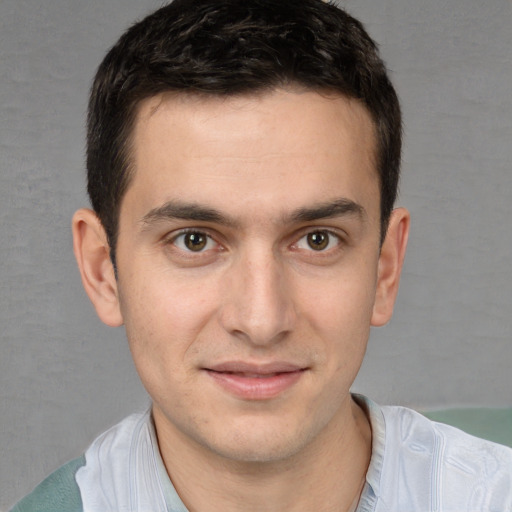 Joyful white young-adult male with short  brown hair and brown eyes