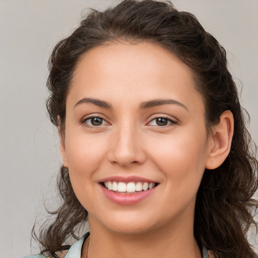 Joyful white young-adult female with medium  brown hair and brown eyes