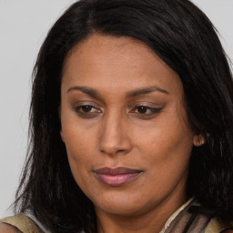 Joyful white adult female with long  brown hair and brown eyes