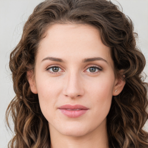 Joyful white young-adult female with long  brown hair and green eyes