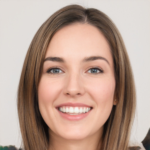 Joyful white young-adult female with long  brown hair and green eyes