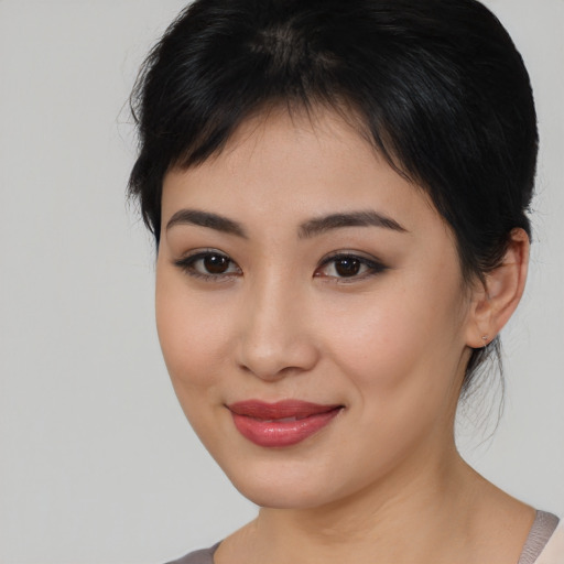 Joyful asian young-adult female with medium  brown hair and brown eyes
