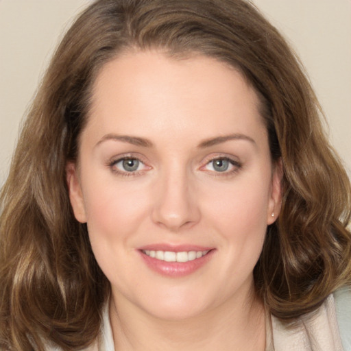 Joyful white young-adult female with long  brown hair and grey eyes