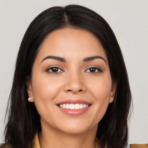 Joyful latino young-adult female with long  black hair and brown eyes