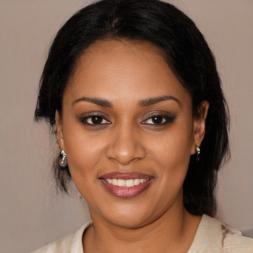 Joyful black young-adult female with medium  brown hair and brown eyes