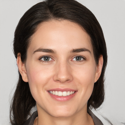 Joyful white young-adult female with medium  brown hair and brown eyes