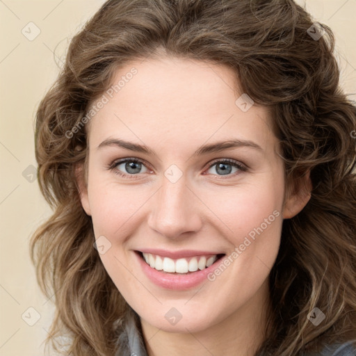 Joyful white young-adult female with long  brown hair and green eyes