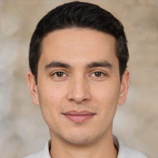 Joyful white young-adult male with short  black hair and brown eyes