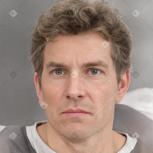 Neutral white adult male with short  brown hair and grey eyes