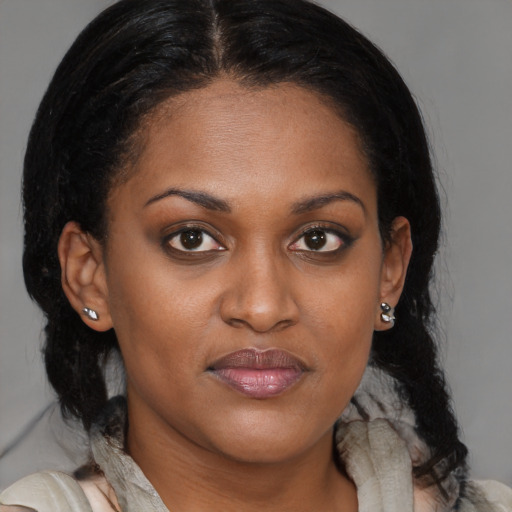 Joyful black young-adult female with medium  brown hair and brown eyes