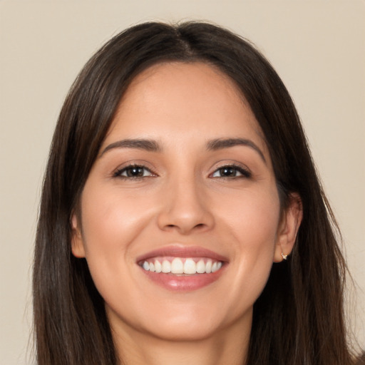 Joyful white young-adult female with long  brown hair and brown eyes