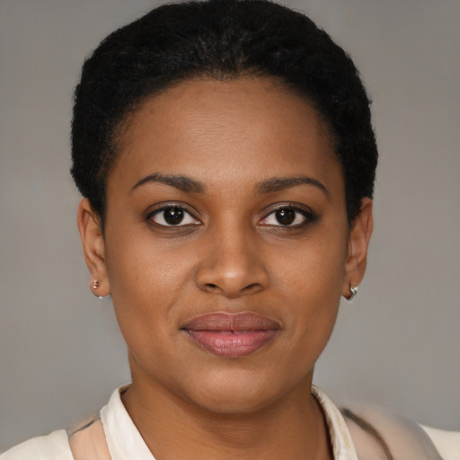 Joyful black young-adult female with short  brown hair and brown eyes