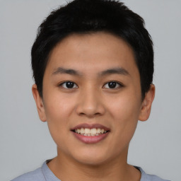 Joyful asian young-adult male with short  black hair and brown eyes