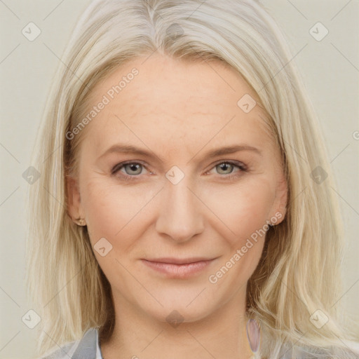 Joyful white adult female with medium  brown hair and blue eyes