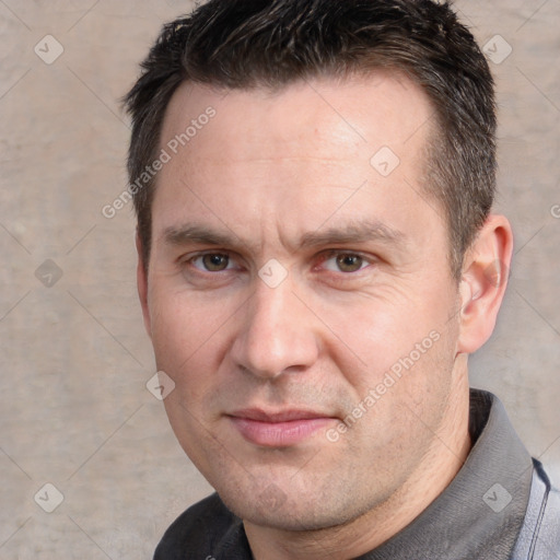 Joyful white adult male with short  brown hair and grey eyes