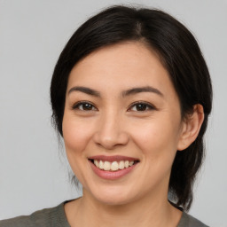 Joyful asian young-adult female with medium  brown hair and brown eyes