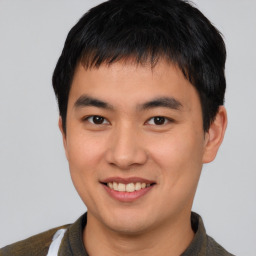 Joyful asian young-adult male with short  brown hair and brown eyes