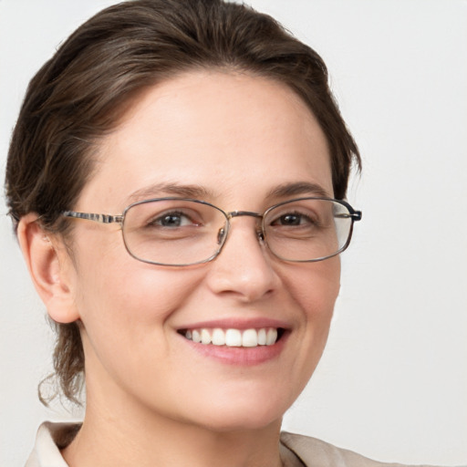 Joyful white adult female with medium  brown hair and grey eyes