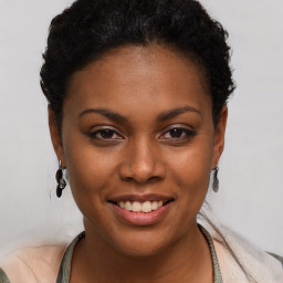 Joyful black young-adult female with short  brown hair and brown eyes