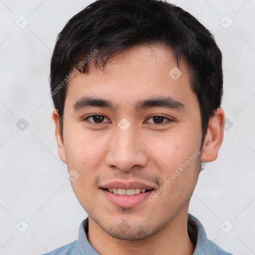 Joyful asian young-adult male with short  brown hair and brown eyes