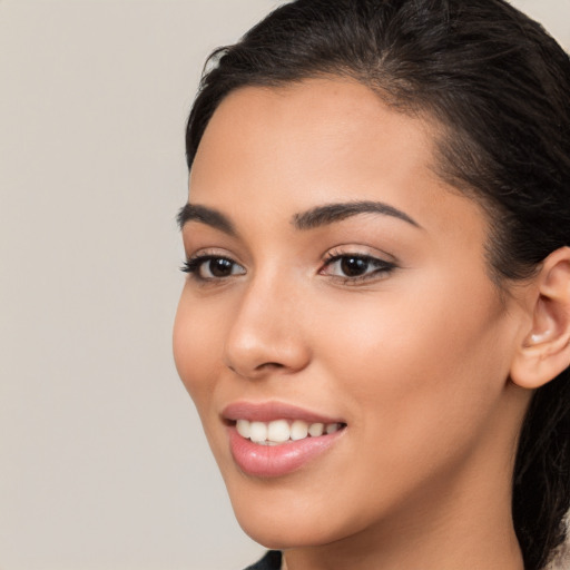 Joyful latino young-adult female with medium  brown hair and brown eyes