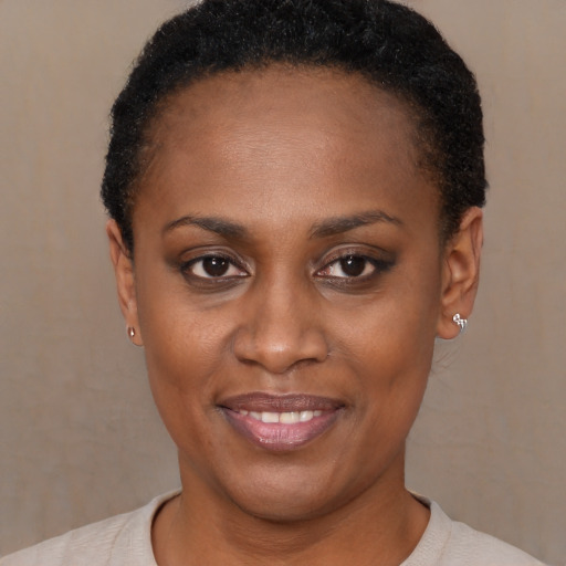 Joyful latino young-adult female with short  black hair and brown eyes