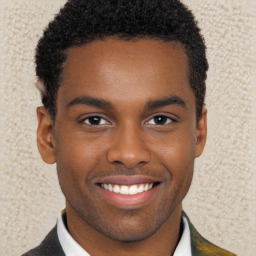 Joyful black young-adult male with short  brown hair and brown eyes