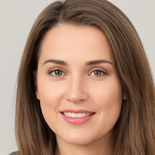 Joyful white young-adult female with long  brown hair and brown eyes