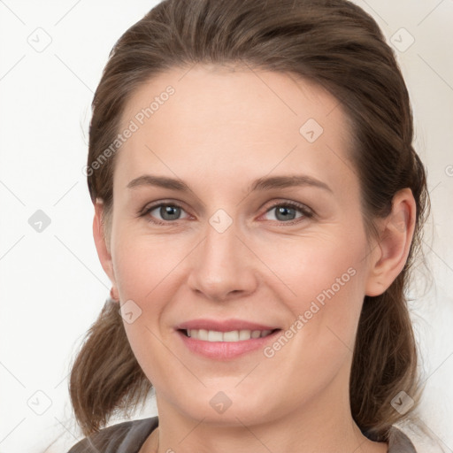 Joyful white young-adult female with medium  brown hair and grey eyes