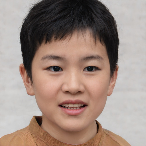 Joyful asian child male with short  brown hair and brown eyes